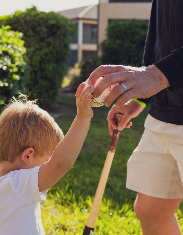 child holding a baseball