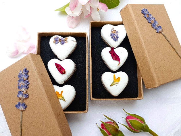 Two boxes of heart-shaped favours decorated with flowers