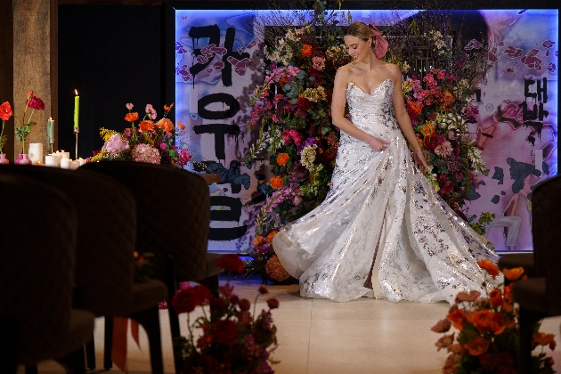 A bride twirling her wedding dress in a room full of flowers