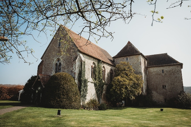 The exterior of a church-like building surrounded by grass