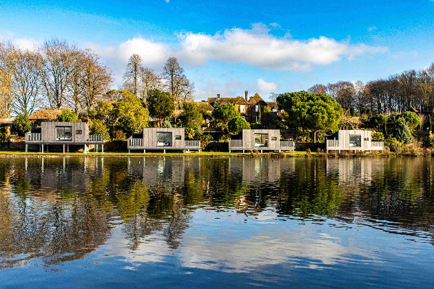 Four buildings overlooking a lake