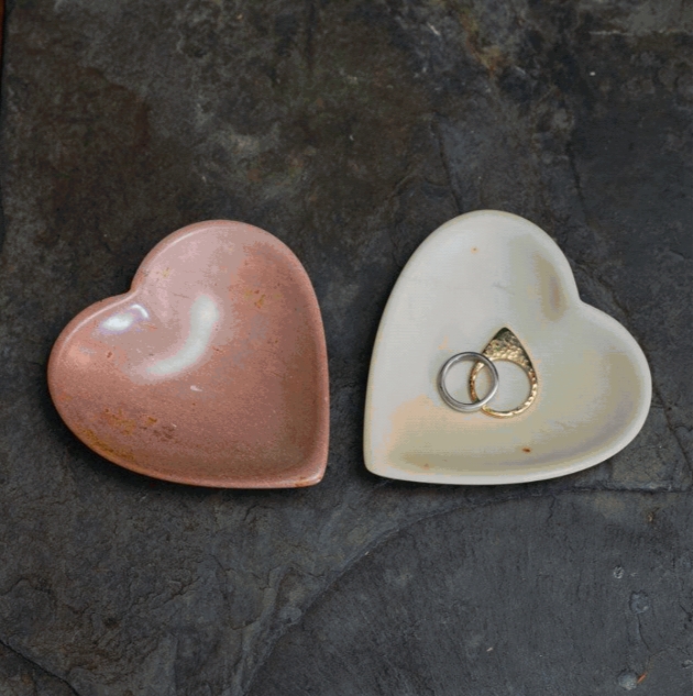 Two heart-shaped bowls, one with rings inside