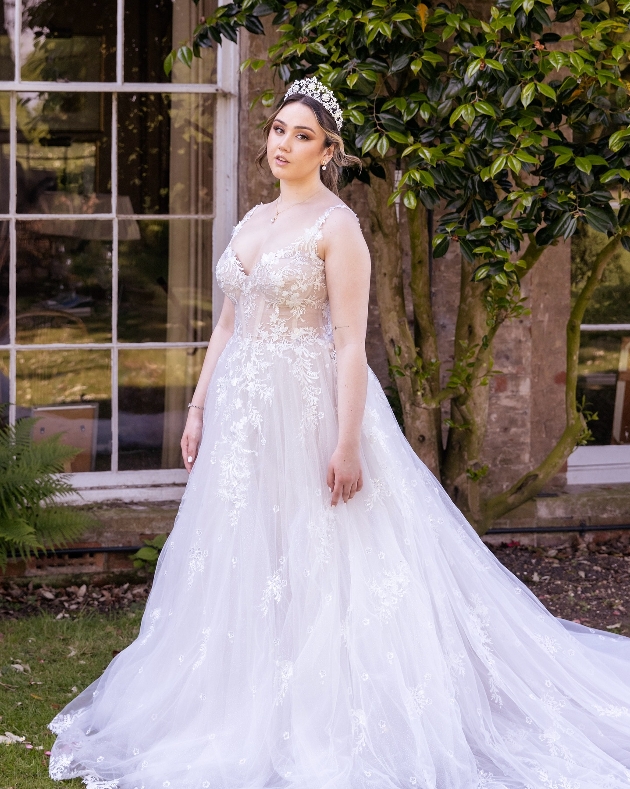 model in wedding dress standing in gardens