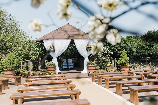 An outdoor ceremony area with wooden benches