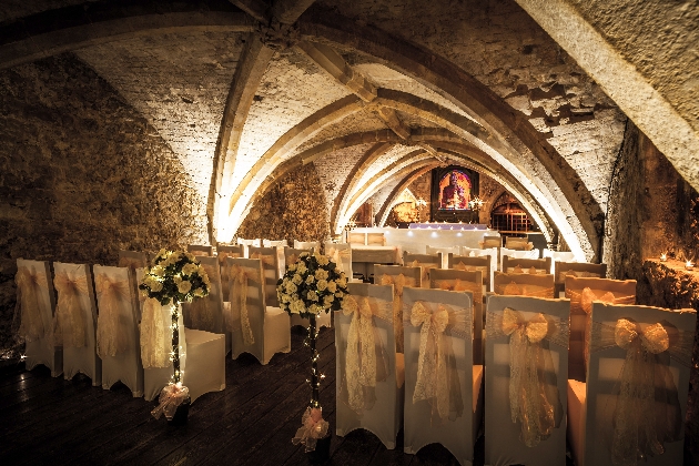 A vault decorated with ceremony chairs and flowers