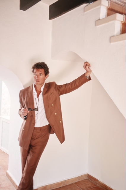 A man wearing a brown suit