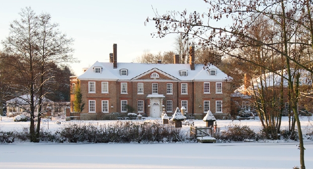 A large country house covered in snow