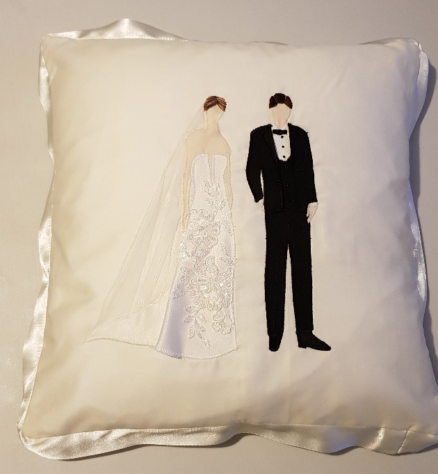 bride and groom detail on a cushion