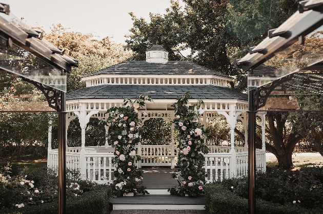 A white gazebo decorated with flowers