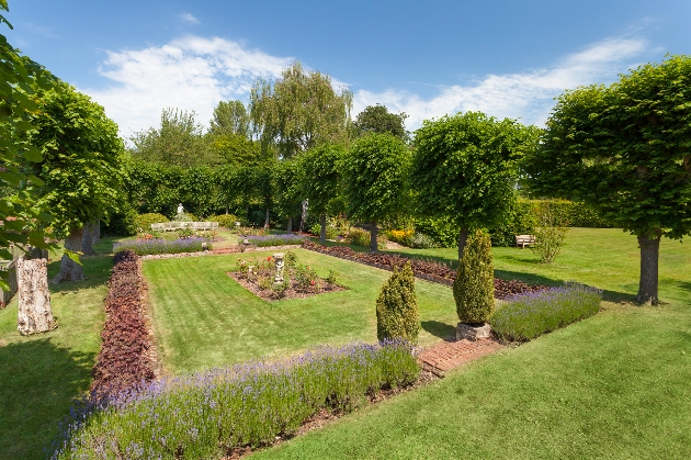 Manicured gardens surrounded by trees