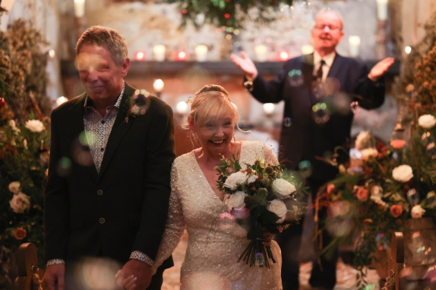 A bride and groom walking down the aisle